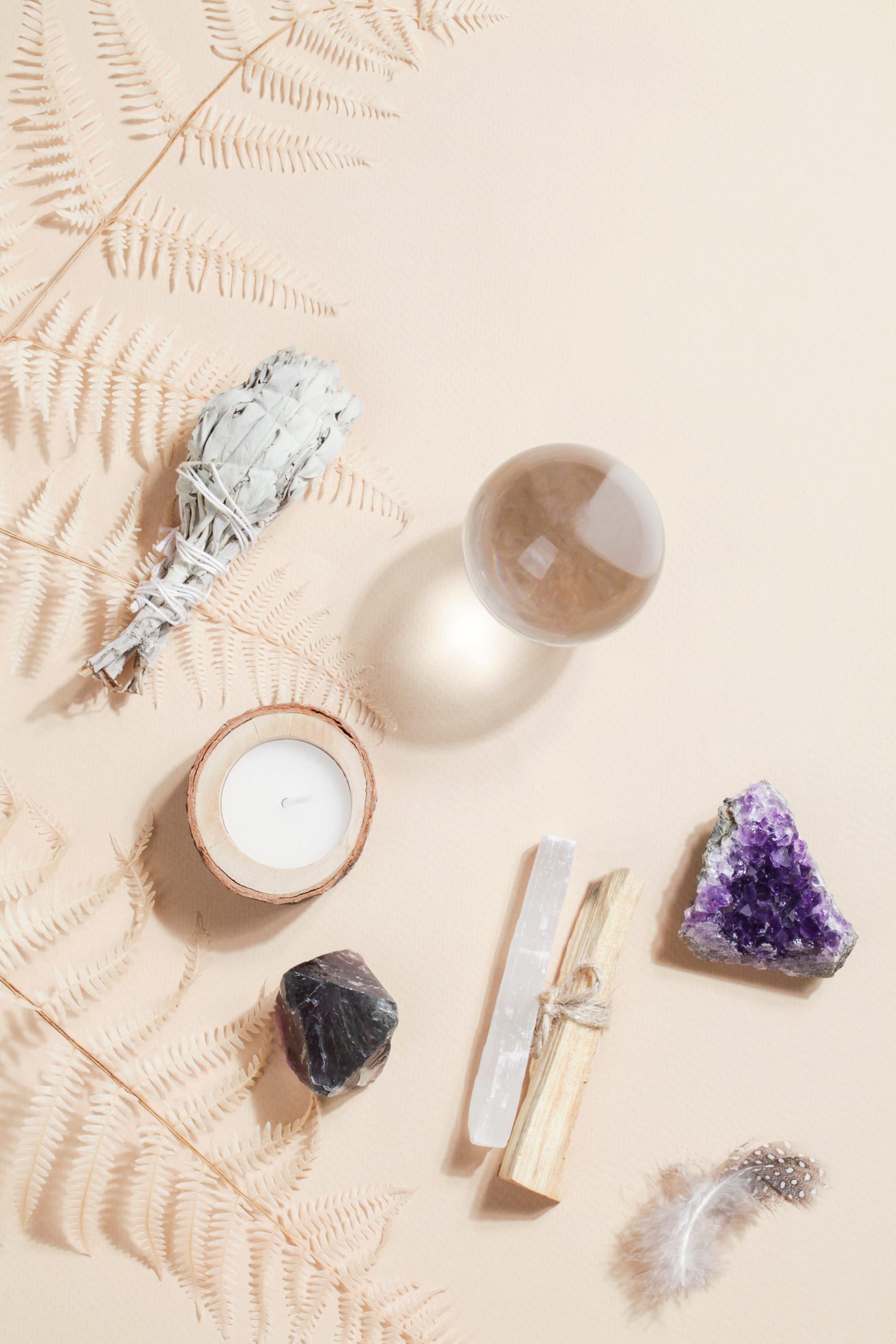 crystals, sage and feather on table