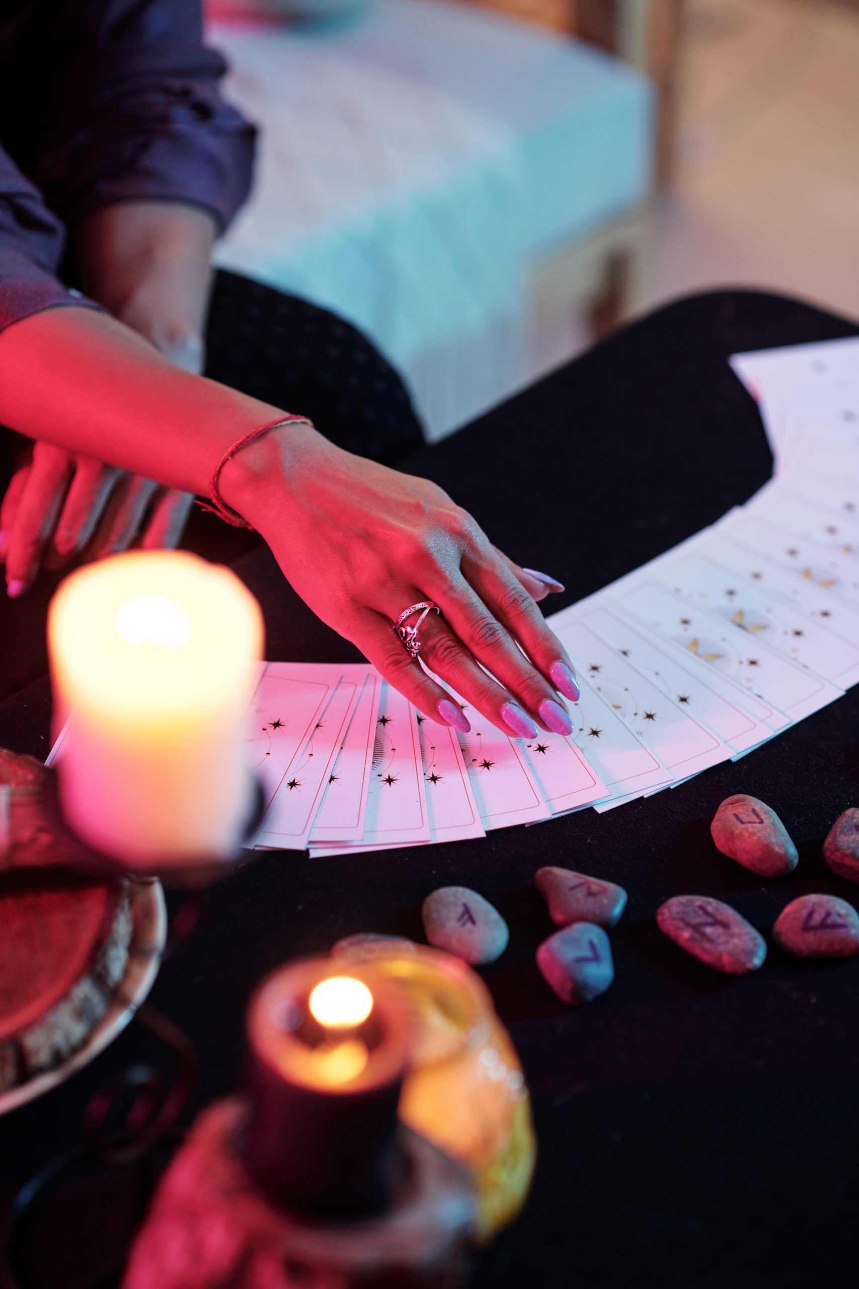 woman's hand over cards on table